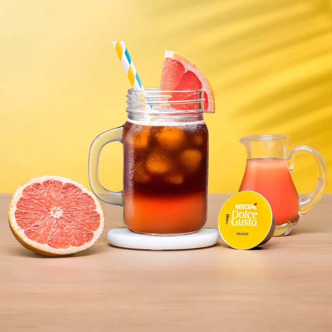 iced grapefruit next to a coffee capsule