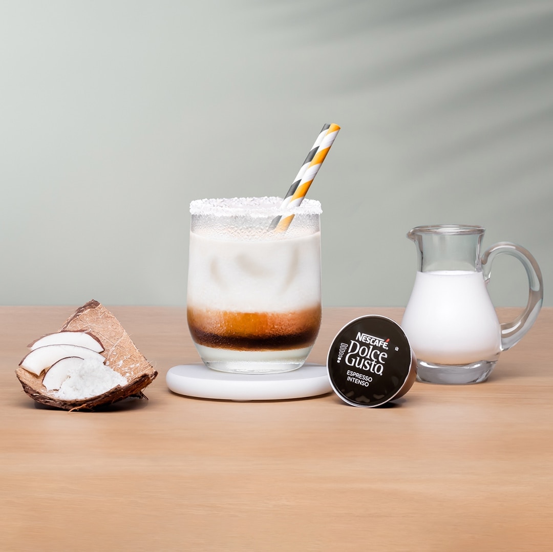 iced espresso next to a coffee capsule